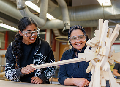 Two people working on a wheel